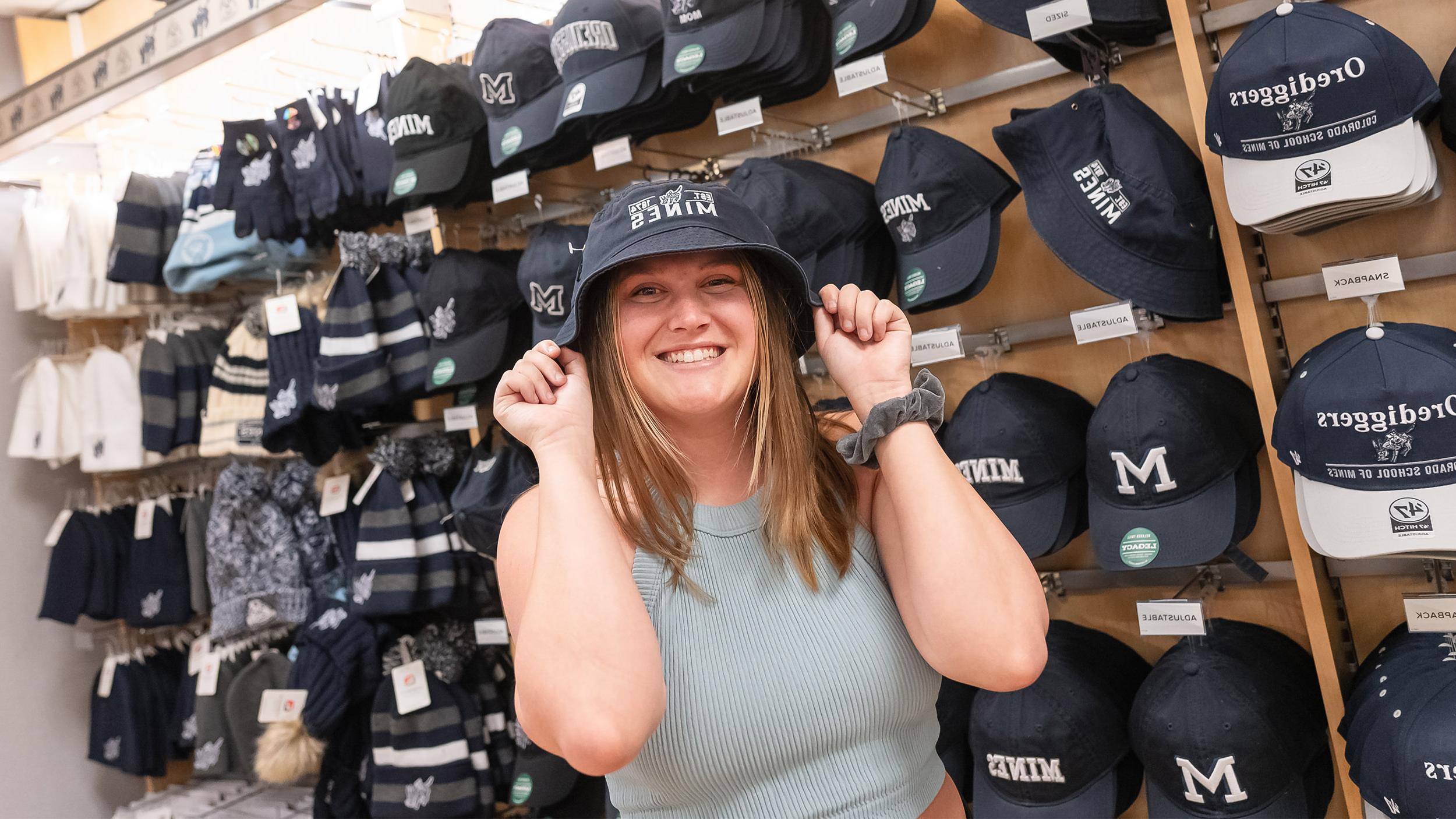 A photo of Olivia wearing a bucket hat in the bookstore.